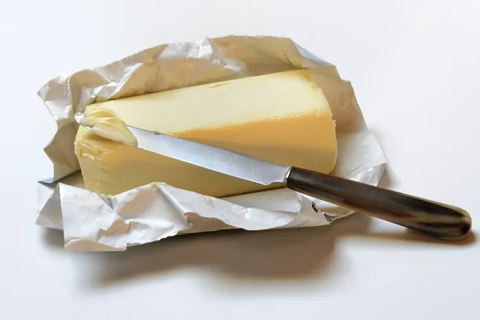 Gerahmter Druck : Butter mit geöffnetem Paket und Messer. Gerahmter Druck : Butter mit geöffnetem Paket und Messer.