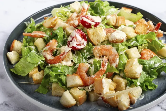 Gerahmter Druck : Salat Caesar, mit Garnelen, auf einem Marmorboden. Gerahmter Druck : Salat Caesar, mit Garnelen, auf einem Marmorboden.