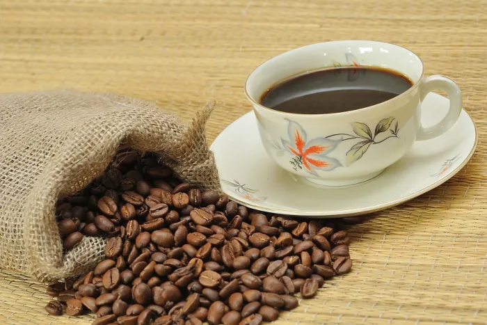 Gerahmter Druck : Kaffeebohnen neben einem Kaffeetasse. Gerahmter Druck : Kaffeebohnen neben einem Kaffeetasse.