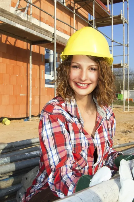Gerahmter Druck : Eine Handwerkerin vor dem Rohbau eines Hauses. Gerahmter Druck : Eine Handwerkerin vor dem Rohbau eines Hauses.