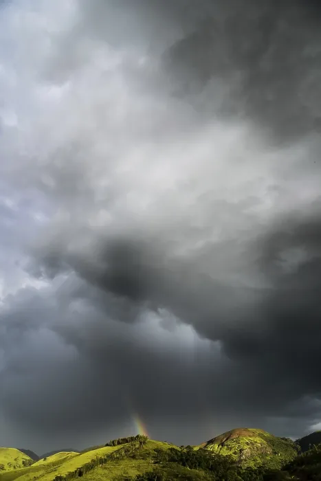 Gerahmter Druck : Dunkle Wolken und Regenbogen über den Bergen. Gerahmter Druck : Dunkle Wolken und Regenbogen über den Bergen.