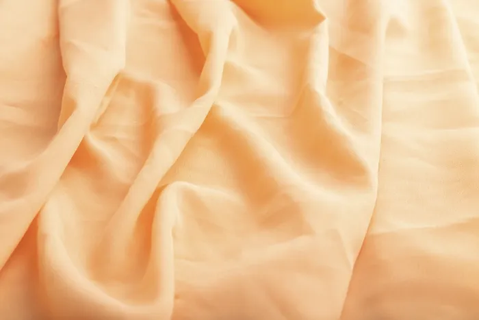 Gerahmter Druck : Stück orangen Leinenstoffes. Gerahmter Druck : Stück orangen Leinenstoffes.