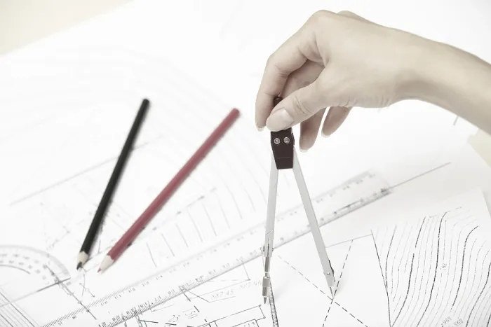 Gerahmter Druck : Die Hand eines Ingenieurs, der an einem Bauentwurf arbeitet. Gerahmter Druck : Die Hand eines Ingenieurs, der an einem Bauentwurf arbeitet.