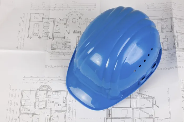 Gerahmter Druck : Helm liegt auf einem Bauplan. Gerahmter Druck : Helm liegt auf einem Bauplan.