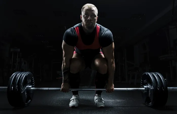 Gerahmter Druck : Ein riesiger Mann bereitet sich darauf vor, ein Übung namens Deadlift auszuführen. Gerahmter Druck : Ein riesiger Mann bereitet sich darauf vor, ein Übung namens Deadlift auszuführen.