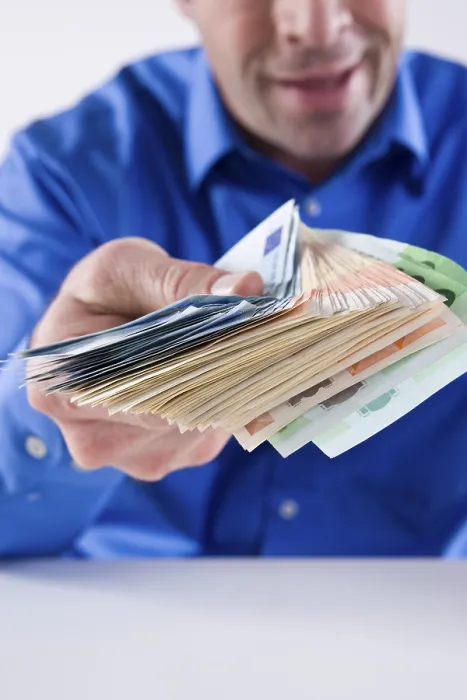 Gerahmter Druck : Ein Mann hält ein Bündel Banknoten. Gerahmter Druck : Ein Mann hält ein Bündel Banknoten.