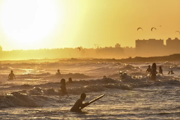 Gerahmter Druck : Menschen baden am Strand bei Sonnenuntergang. Gerahmter Druck : Menschen baden am Strand bei Sonnenuntergang.