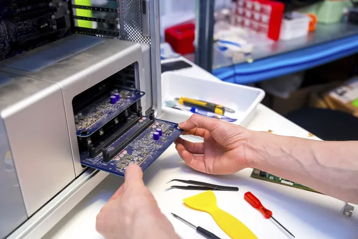 Gerahmter Druck : Techniker öffnet den hinteren Teil eines Computers, um ihn in einer Werkstatt zu reparieren. Gerahmter Druck : Techniker öffnet den hinteren Teil eines Computers, um ihn in einer Werkstatt zu reparieren.
