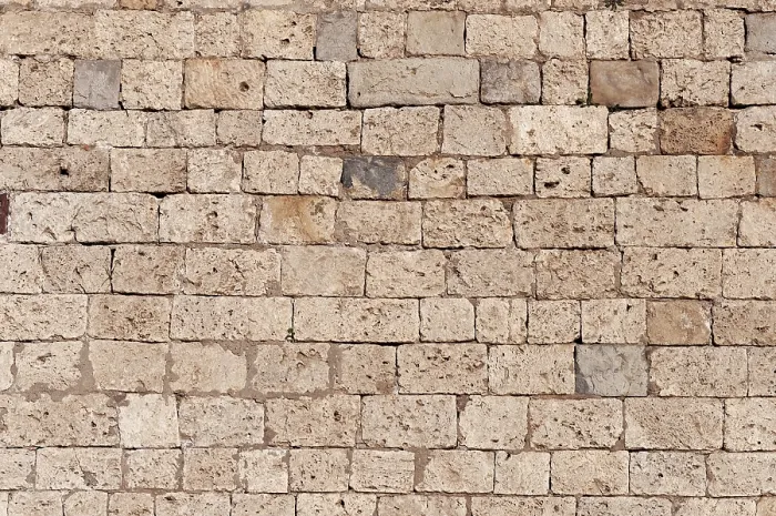 Gerahmter Druck : Textur einer alten braunen Kalksteinmauer als Hintergrund. Gerahmter Druck : Textur einer alten braunen Kalksteinmauer als Hintergrund.