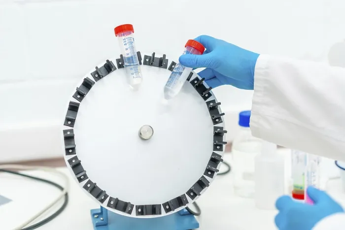 Gerahmter Druck : Oberansicht eines Wissenschaftlers, der Proben in einer Zentrifugenmaschine einsetzt. Gerahmter Druck : Oberansicht eines Wissenschaftlers, der Proben in einer Zentrifugenmaschine einsetzt.