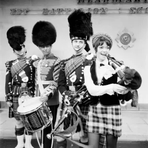 Black and white print of a young woman attempting to play the bagpipes