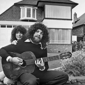 Print of Jeff Lynne sitting in a driveway with an acoustic guitar Print of Jeff Lynne sitting in a driveway with an acoustic guitar