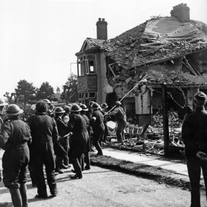ARP personnel pulling down rubble in England, April 1940 Print ARP personnel pulling down rubble in England, April 1940 Print