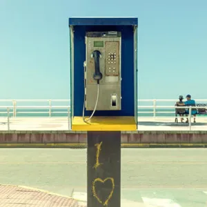 Dirty phone booth with romantic graffiti print