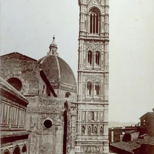 Giotto's Campanile in Florence. On the left partial view of the Baptistry and Arnolfo's facade of the Cathedral. In the background the Cathedral dome Giotto's Campanile in Florence. On the left partial view of the Baptistry and Arnolfo's facade of the Cathedral. In the background the Cathedral dome