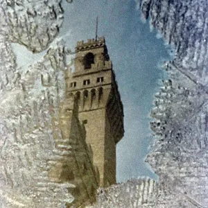 Tower (Tower of Arnolfo) of the Palazzo Vecchio in Florence reflected in a puddle Tower (Tower of Arnolfo) of the Palazzo Vecchio in Florence reflected in a puddle