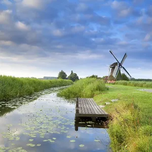 Dutch Windmill Print by River with Reflected Blue Sky Dutch Windmill Print by River with Reflected Blue Sky