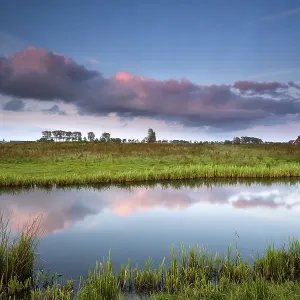 Small House by River at Dramatic Pink Sunset Print Small House by River at Dramatic Pink Sunset Print