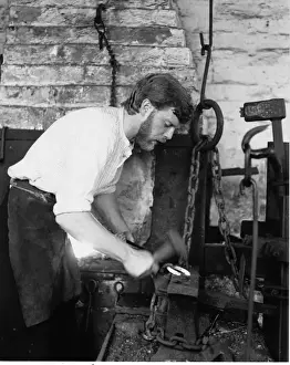 West Midlands Industry Drucke: Blacksmith in his forge, working on a horseshoe