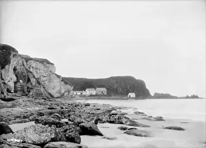 Northern Ireland County Antrim Drucke: Distant view of Portbraddon from along the coastline