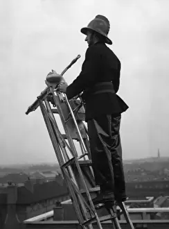 LFB Service History Drucke: Firefighter using hook belt at top of ladder