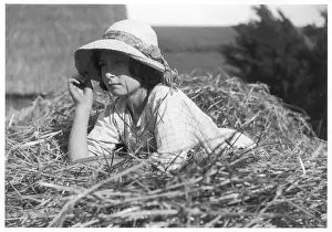 Rustic Landscape Photography Drucke: Girl Lying on Haystack