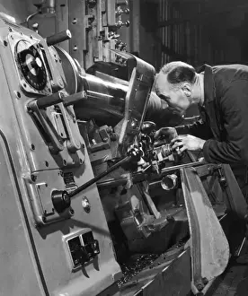 Industrial Manufacturing Process Drucke: A lathe operator at work