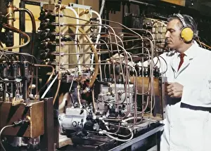 Laboratory Technician Drucke: A technician adjusts delicate pipework