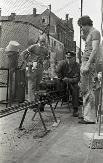 Railway Transport Drucke: Train driver prepares engine on model steam train