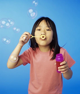 Young Girl Playing Outside Drucke: Blowing bubbles