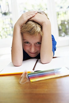 Childhood Education Photos Drucke: Boy with pens and exercise book