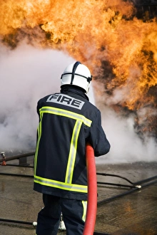Protective Clothing Equipment Drucke: Firefighter extinguishing a fire