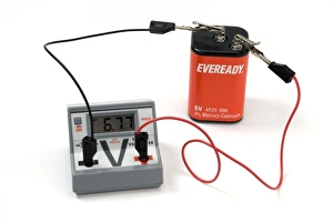 Drucke von Messen der Spannung einer Batterie mit einem Voltmesser, das zwischen den Terminals der Batterie angeschlossen ist, um ihre Spannung zu messen. Der Meter zeigt eine Lesung von 6,77 V an Bilder Datiert 2009 Juli: Messen der Batteriepotential