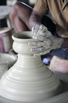 Potter At Work Drucke: Potter making pot of clay