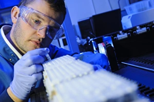 Scientific Experiment Setup Drucke: Scientist examining micro tube samples