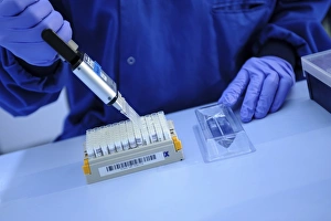 Scientist In Lab Coat Drucke: Scientist using multipipette