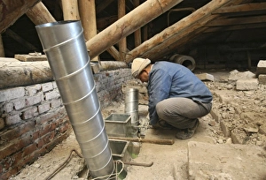 Building Renovation Drucke: Worker installing ventilation