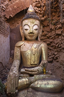 Buddha image inside a ruined stupa