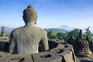 Buddha Statue Indonesia Drucke: Buddha sitting in a stupha in the temple complex of Borobodur