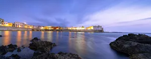 Southern Italy Beaches Drucke: Clouds over Gallipoli washed by the Ionic Sea at dusk, Lecce province, Salento, Apulia