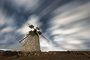 Atlantic Ocean Views Europe Drucke: Clouds in the starry sky over a traditional windmill, La Oliva, Fuerteventura