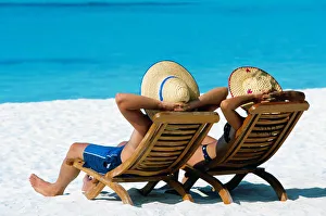 Paar liegt auf Hängematten am Strand der Malediven im Indischen Ozean Asien