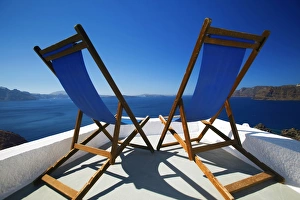 Empty Beach In Greece Drucke: Deck chairs on terrace overlooking ocean