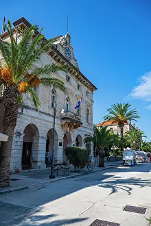 Stari Grad Croatia Drucke: Exploring Stari Grad with palm trees, historic buildings, and clear blue skies in Croatia