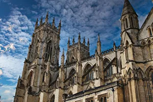Gothic Cathedral Architecture Drucke: Gothic cathedral tower against a dramatic cloudy sky