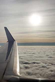 Europe Cloudy Skies Drucke: Plane wing with low lying clouds and sunburst, United Kingdom, Europe