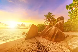 African Island Getaways Drucke: Rocks on beach and palm trees, Anse Source d Argent at sunset, La Digue, Seychelles
