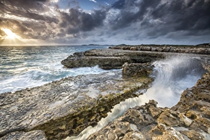 Central America Coastal Scenery Drucke: Rocks and crashing waves at Devils Bridge, a natural arch carved by the sea, Antigua