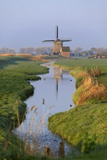 Colourful European Scenery Drucke: Typical windmill reflected in the canal at dawn, Berkmeer, municipality of Koggenland