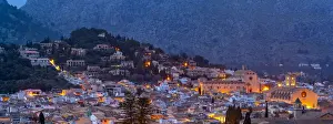 Majorca Balearic Islands Drucke: View of churches and rooftops of Pollenca with mountain in background at dusk